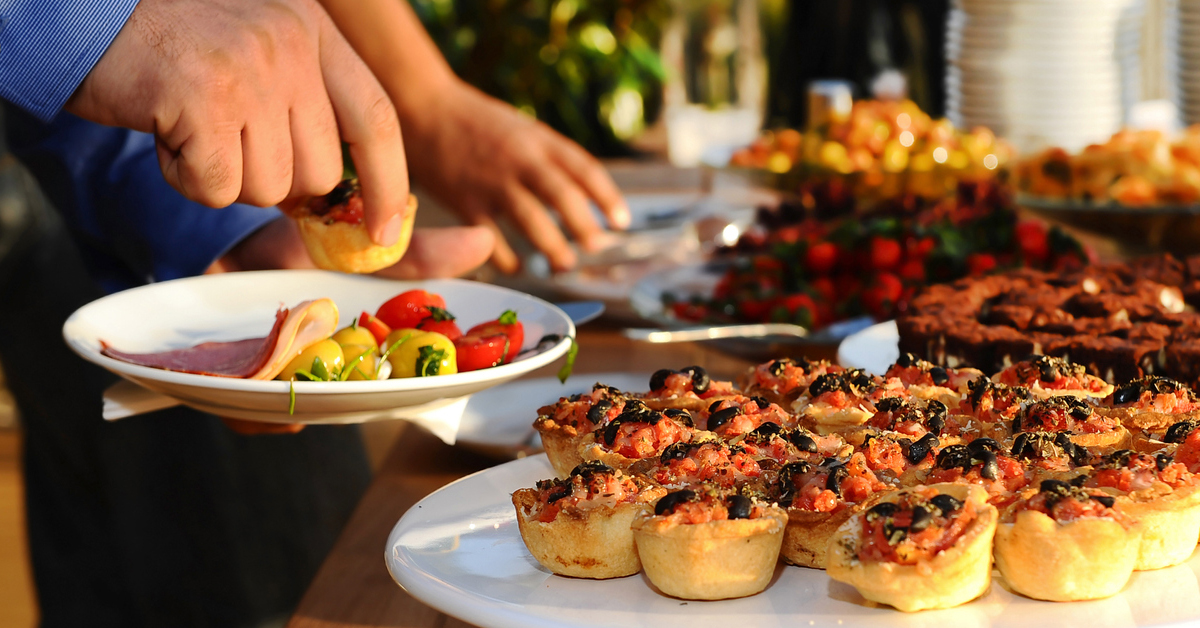 a person sitting at a table with a plate of food