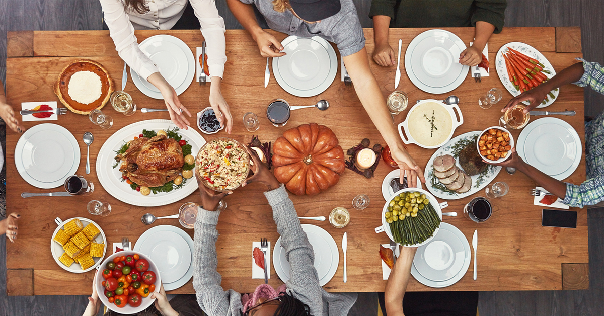 a group of people sitting at a table with a plate of food