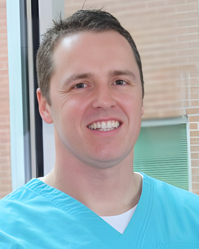 a smiling man in a blue shirt