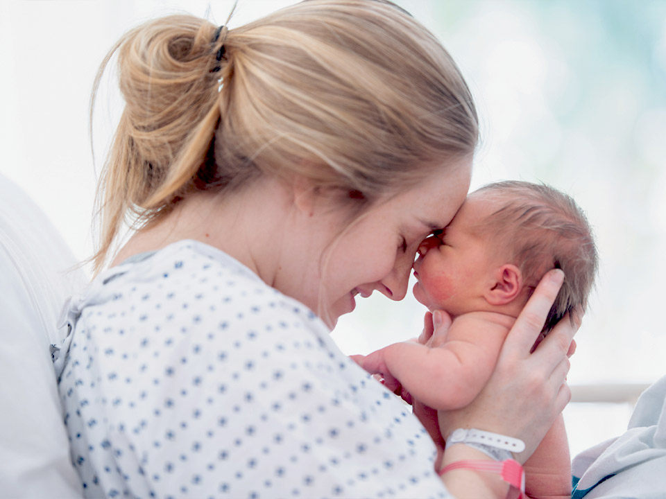 a woman holding a baby