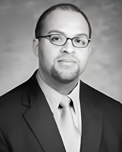 a man wearing a suit and tie looking at the camera