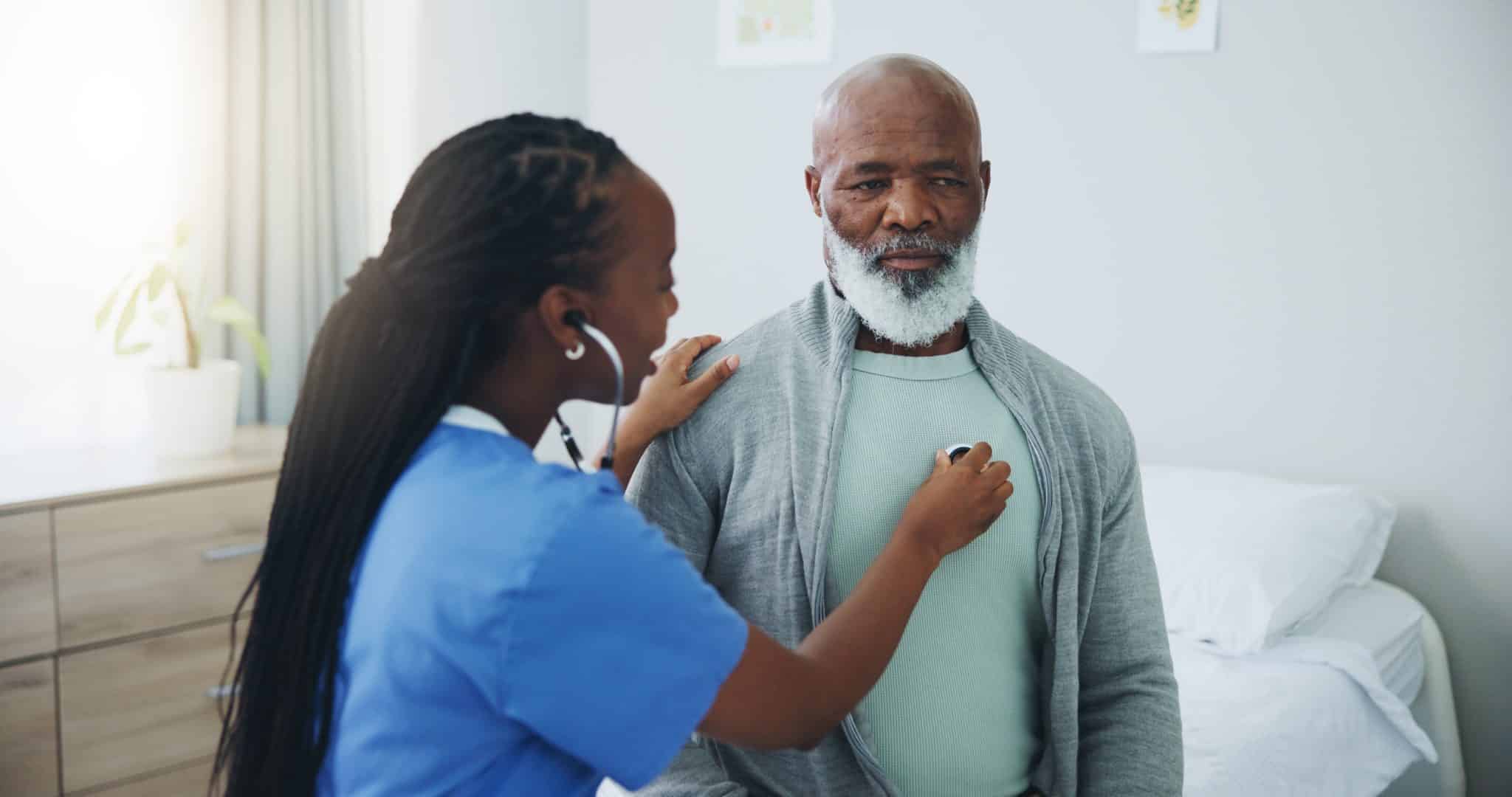 A doctor at UAB Medical West using a stethoscope for a heartbeat assessment during cardiac rehabilitation.