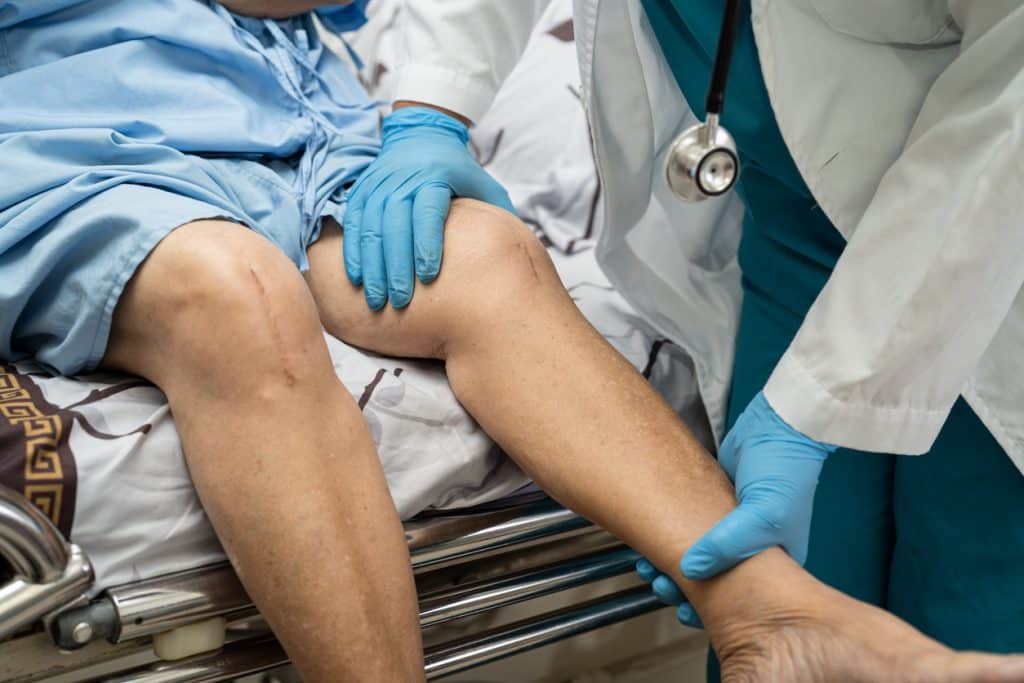 A patient being examined by a doctor at UAB Medical West after knee joint replacement surgery.